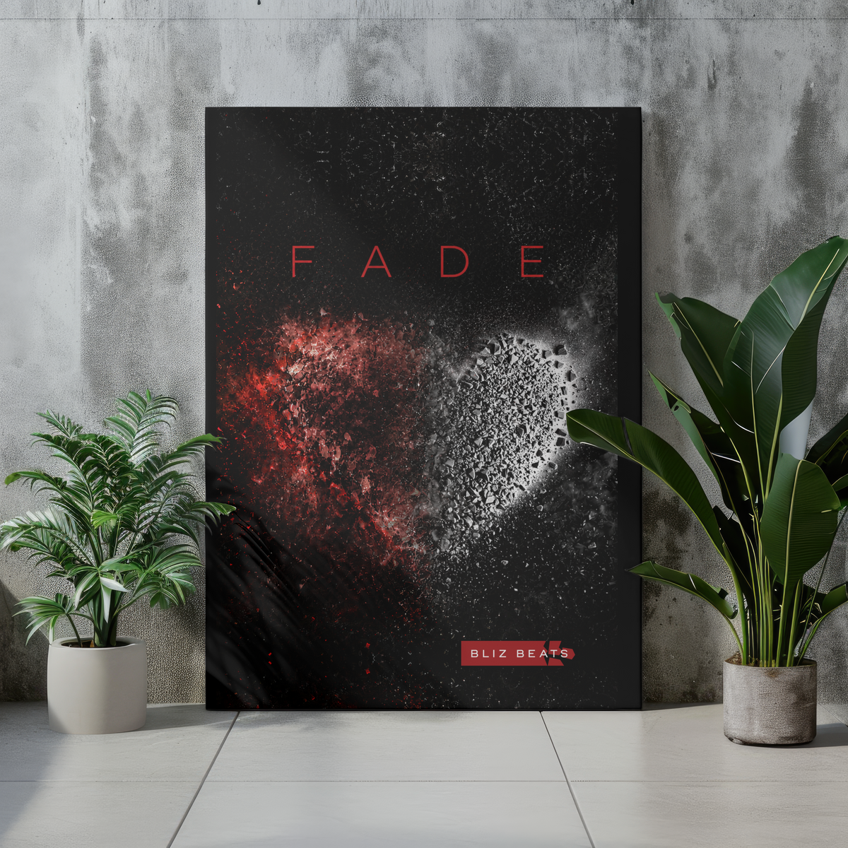 A vertical wall art poster leaning against a concrete wall on a light floor, flanked by two potted green plants. The poster has a black background with a red-and-white heart made from paint splatter and the word 'FADE' in red at the top, plus a small 'BL12 BEATS' label near the bottom.